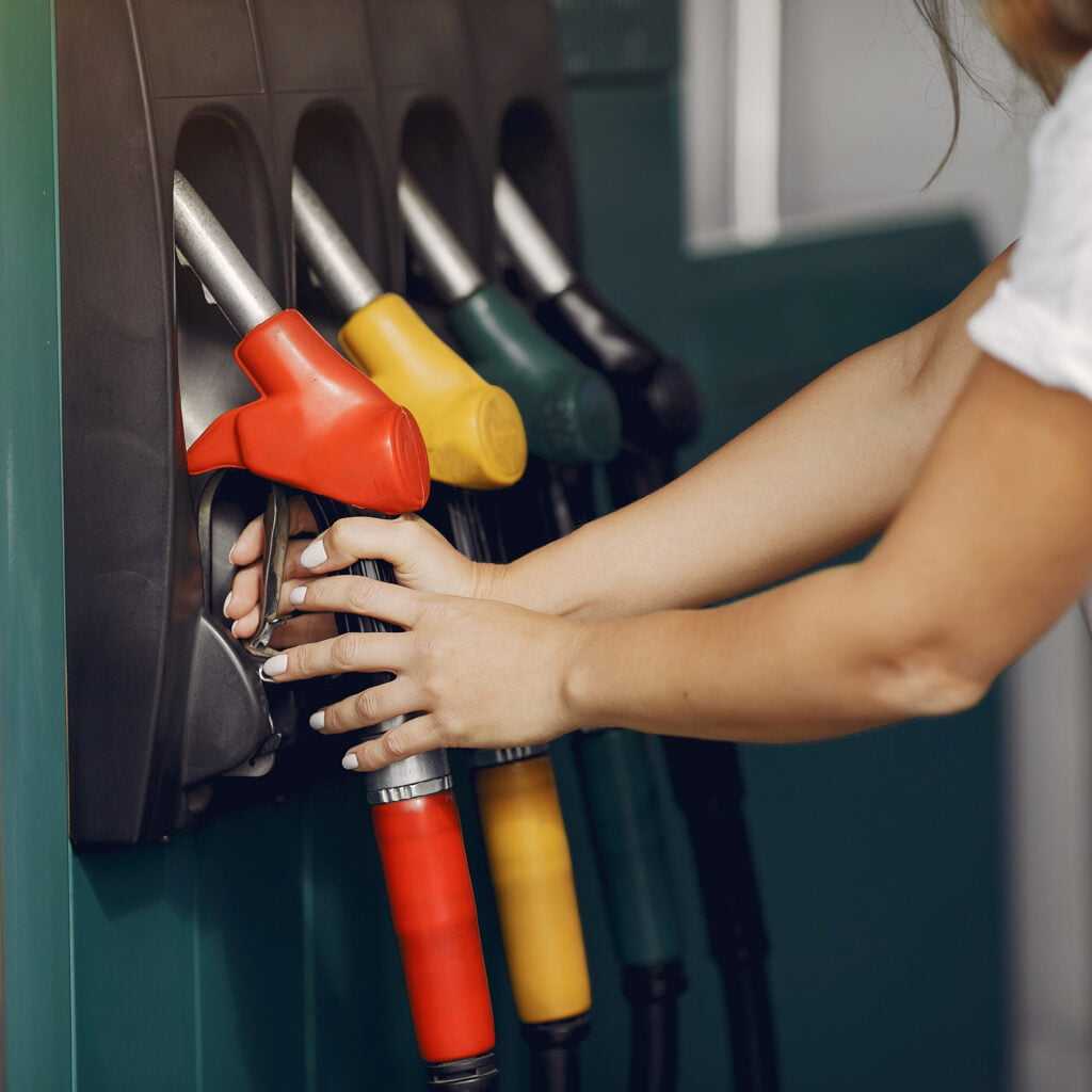 elegant woman standing gas station